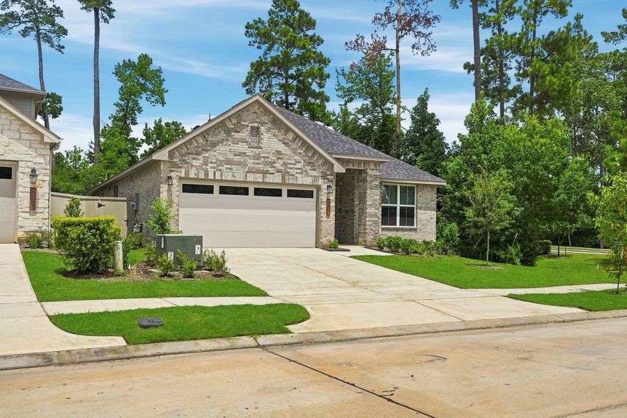 Front exterior of a new home in Audubon, Magnolia, TX, highlighting curb appeal (Image 17). Front exterior of a new home in Audubon, Magnolia, TX, highlighting curb appeal (Image 17).