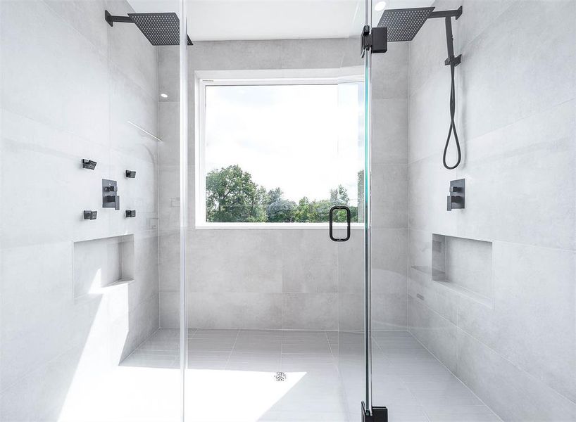 Experience spa-like luxury with a sophisticated shower system, featuring rejuvenating rain heads, a high-pressure power head, a relaxing body sprayer, and a versatile hand sprayer.