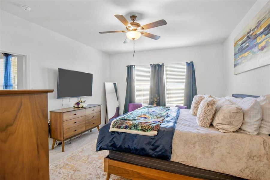 Bedroom with light carpet and ceiling fan