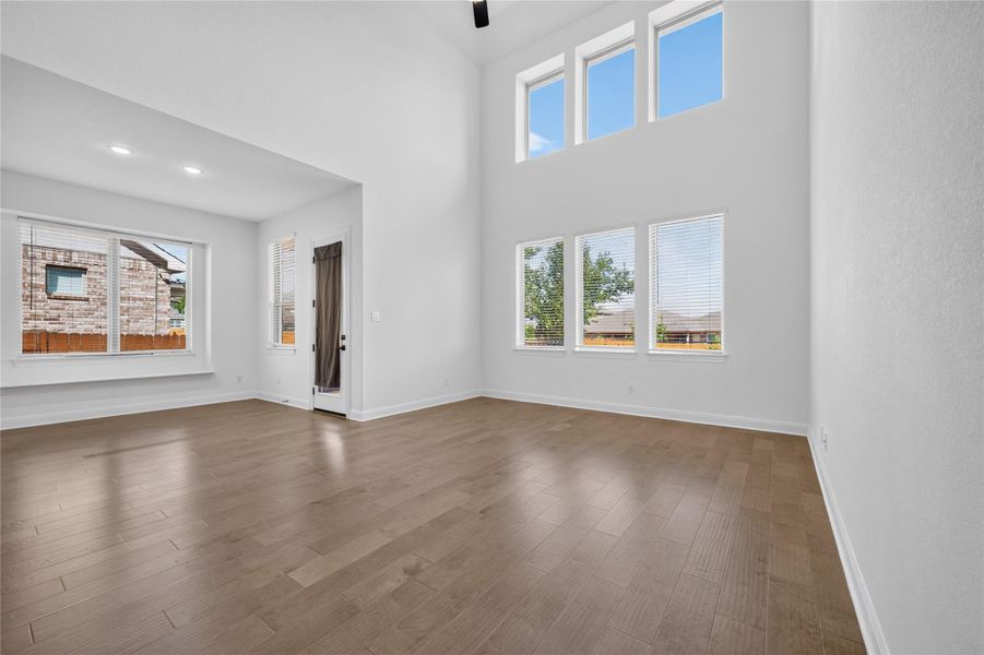 Soaring ceilings and rich wood floors anchor this sun-drenched, open-concept living space. Soaring ceilings and rich wood floors anchor this sun-drenched, open-concept living space.