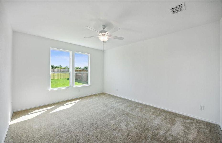 Spacious owner's suite with large windows *real home pictured