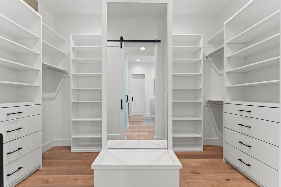 Boutique-worthy organization with seating, built-ins, and plenty of adjustable space for a truly tailored lifestyle.