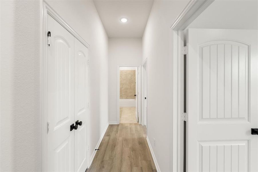 Corridor featuring light wood-style floors and recessed lighting
