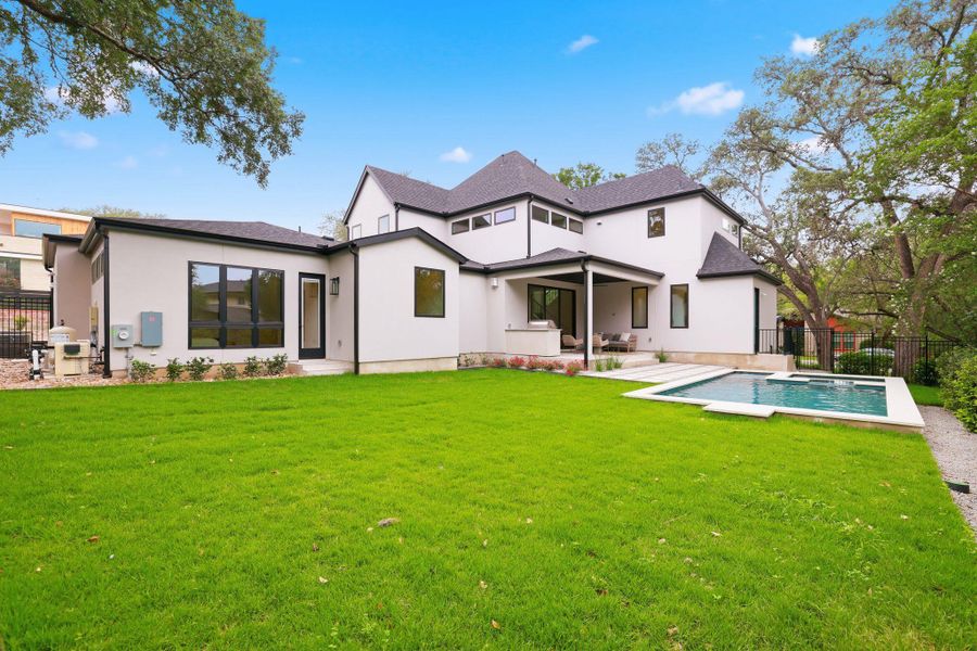 Contemporary exterior with stucco finish and black-framed windows