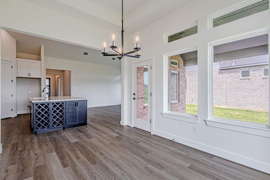 Large windows frame peaceful backyard views while bringing abundant natural light into the main living areas Large windows frame peaceful backyard views while bringing abundant natural light into the main living areas