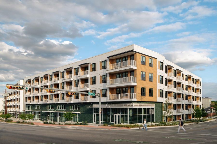 The southwest corner of The Code highlights the building’s design by STG Design, featuring green tile accent balconies and ground floor retail dedicated to health, wellness, and dining. A modern neighborhood presence designed to live, stay, and connect.