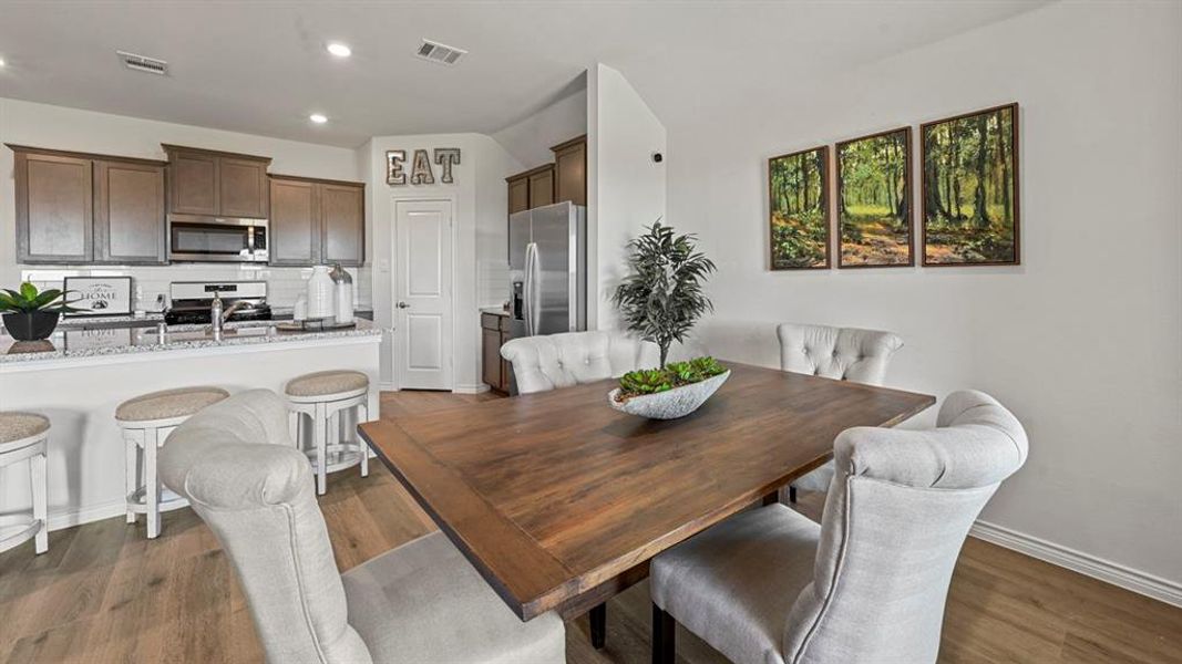 Dining space featuring recessed lighting and dark wood-style flooring