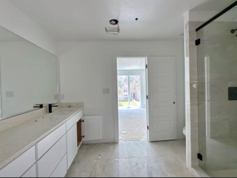 Bathroom with vanity and a stall shower Bathroom with vanity and a stall shower