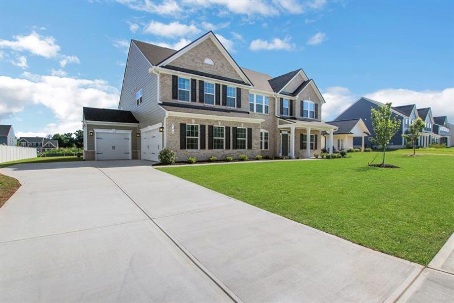 Front exterior of a new home in Edinburgh, Locust Grove, GA, highlighting curb appeal (Image 25).