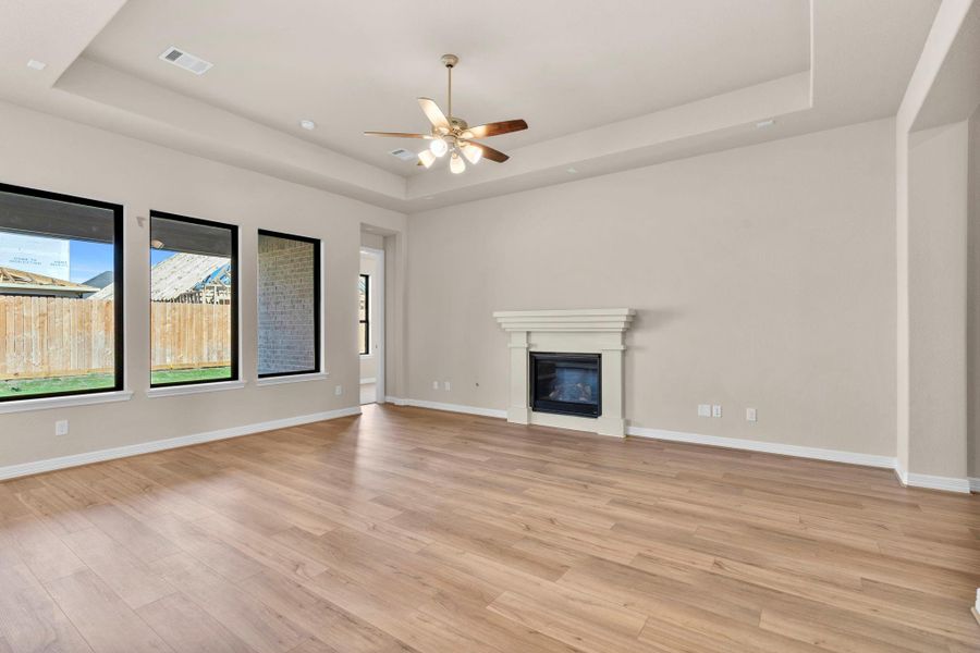 Your family room has ample space to entertain family and friends. This space features beautiful floors, fresh paint, ceiling fan with lighting, and high ceilings. Your family room has ample space to entertain family and friends. This space features beautiful floors, fresh paint, ceiling fan with lighting, and high ceilings.