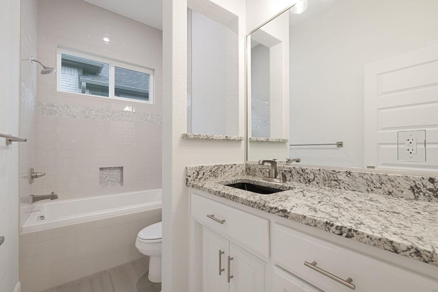 Bathroom featuring vanity and tiled shower / bath combo