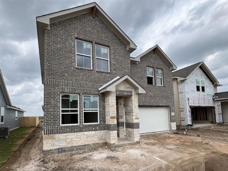 Front exterior of a new home in Rolling Glen, Hutto, TX, highlighting curb appeal (Image 2).