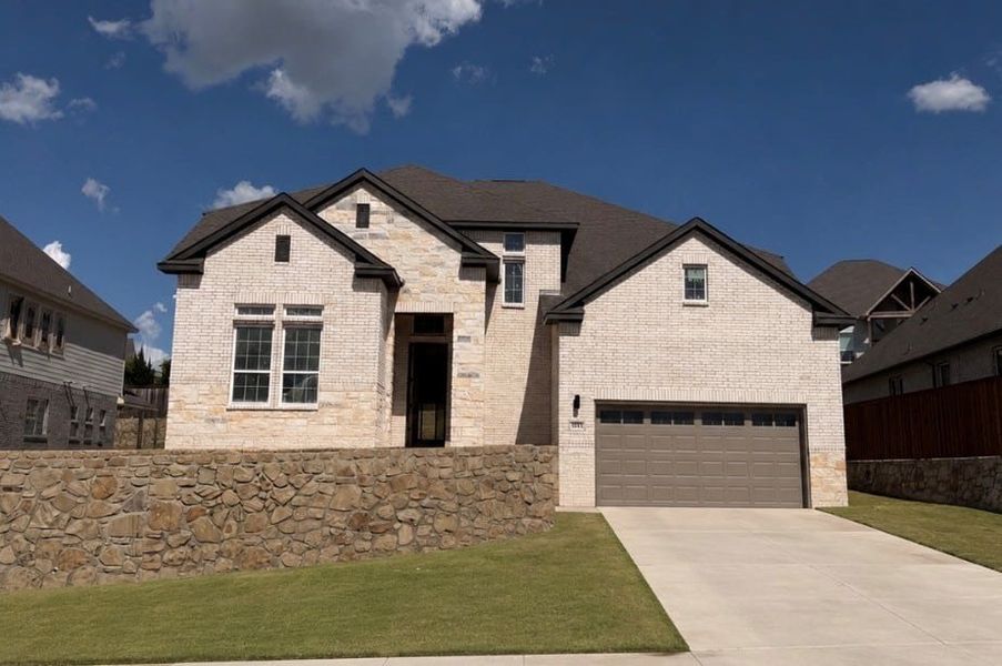 Front exterior of a new home in Walsh, Fort Worth, TX, highlighting curb appeal (Image 1). Front exterior of a new home in Walsh, Fort Worth, TX, highlighting curb appeal (Image 1).