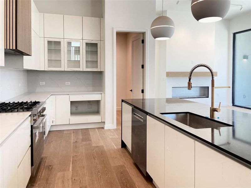 Modern kitchen featuring a large quartz island. (construction photos - professional photos upon completion) Modern kitchen featuring a large quartz island. (construction photos - professional photos upon completion)