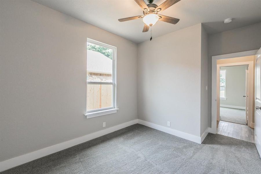 Spare room featuring hardwood / wood-style flooring and ceiling fan