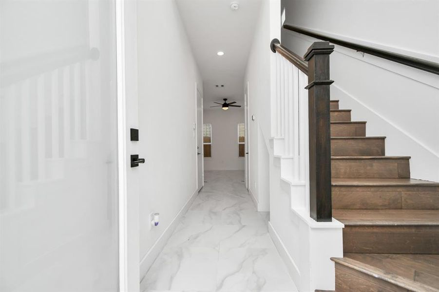 Enjoy the elegance in contrast in this elegant entryway with beautiful tiled flooring leading to first-floor living and the engineered hardwood stairway leading to the second floor.