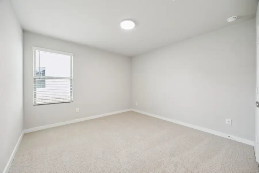 Bedroom in the Hayden home plan by Trophy Signature Homes – REPRESENTATIVE PHOTO