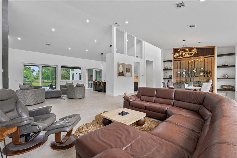 This floorplan seamlessly integrates the living, dining, and kitchen areas under 25ft vaulted ceilings.