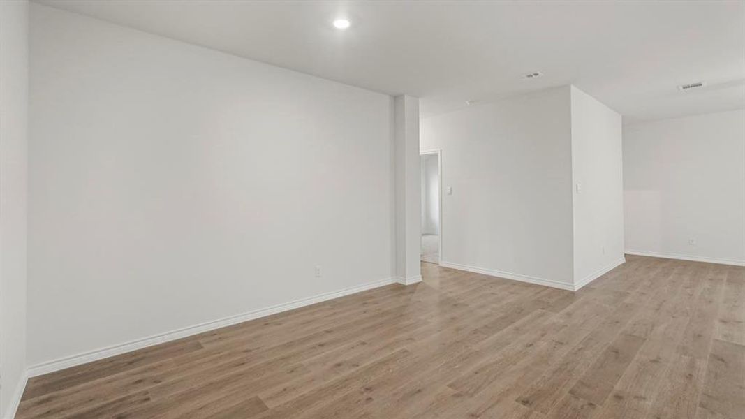 Empty room with light wood-style flooring and baseboards Empty room with light wood-style flooring and baseboards