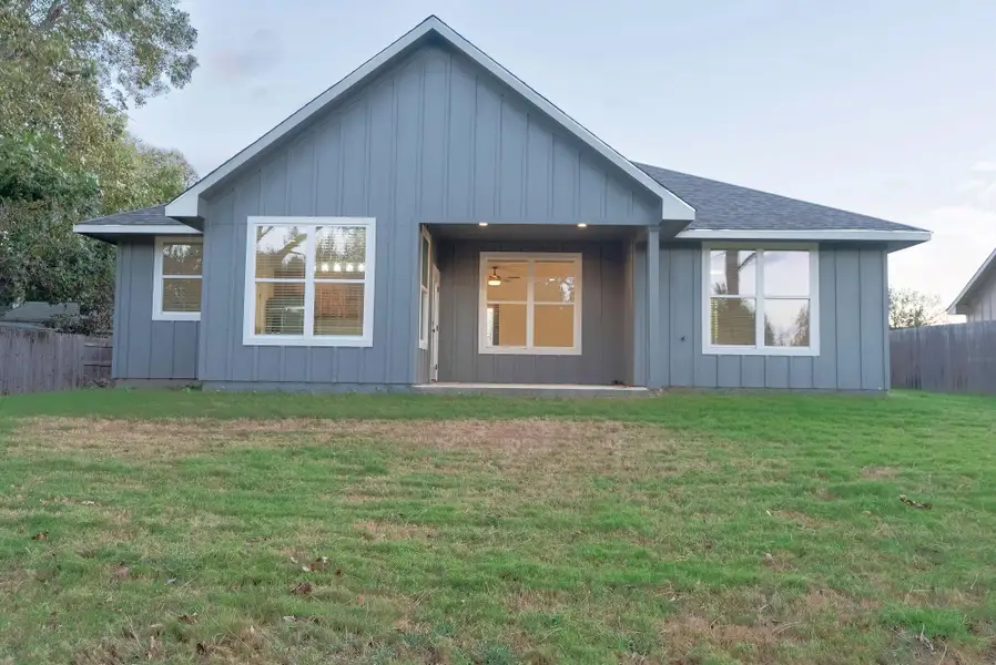View of front facade featuring board and batten siding and a shingled roof View of front facade featuring board and batten siding and a shingled roof