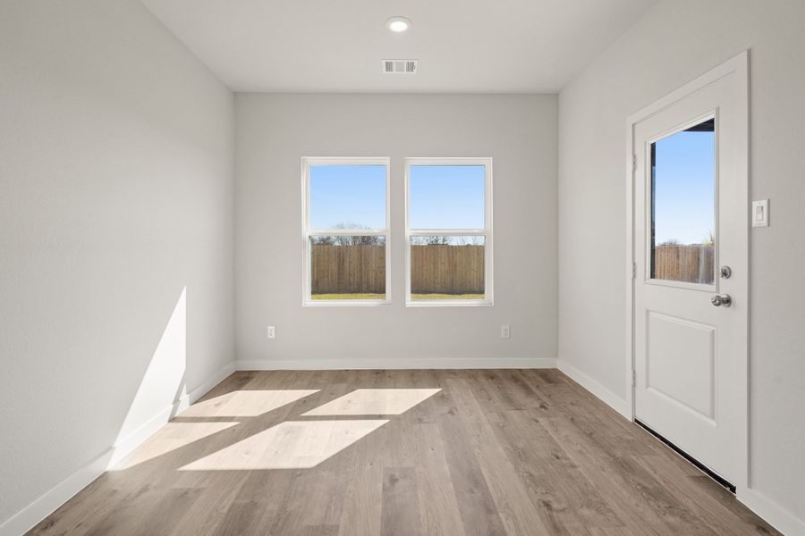 A room with a wood floor and a white door with a window. A room with a wood floor and a white door with a window.