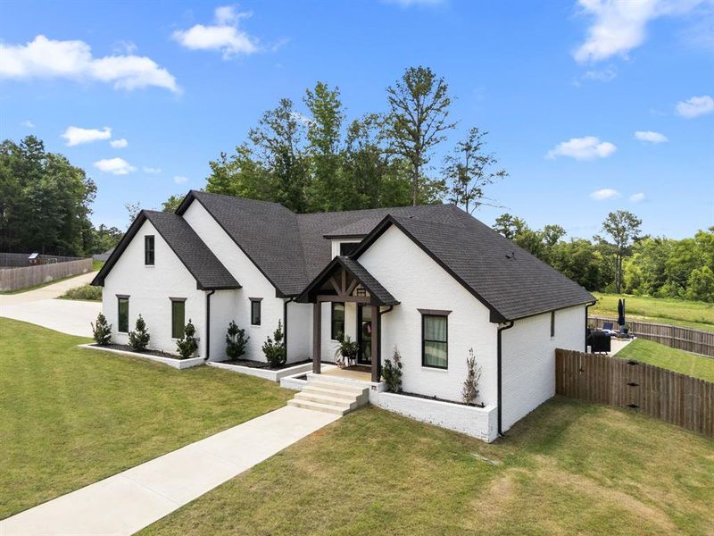Modern farmhouse style home with brick siding and a shingled roof Modern farmhouse style home with brick siding and a shingled roof