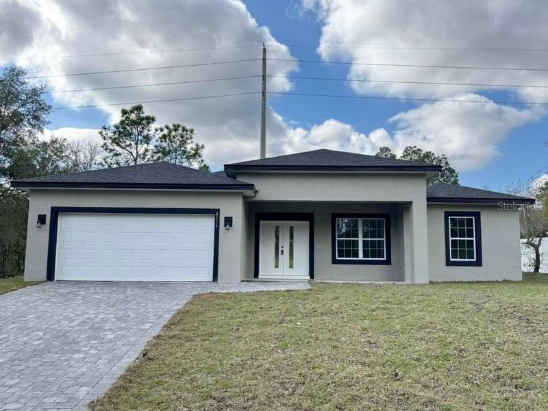 Front exterior of a new home in , Citrus Springs, FL, highlighting curb appeal (Image 1). Front exterior of a new home in , Citrus Springs, FL, highlighting curb appeal (Image 1).