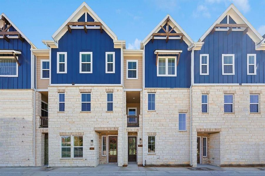 Multi unit property with board and batten siding and stone siding