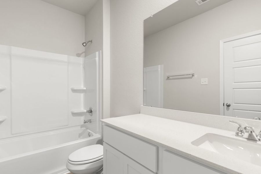 Image of a bedroom with a white double vanity, a large mirror, a white shower with a tub Image of a bedroom with a white double vanity, a large mirror, a white shower with a tub