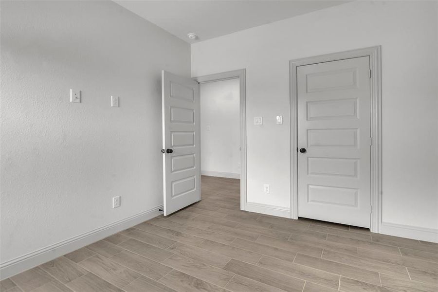 Unfurnished bedroom with baseboards and light wood-style flooring Unfurnished bedroom with baseboards and light wood-style flooring