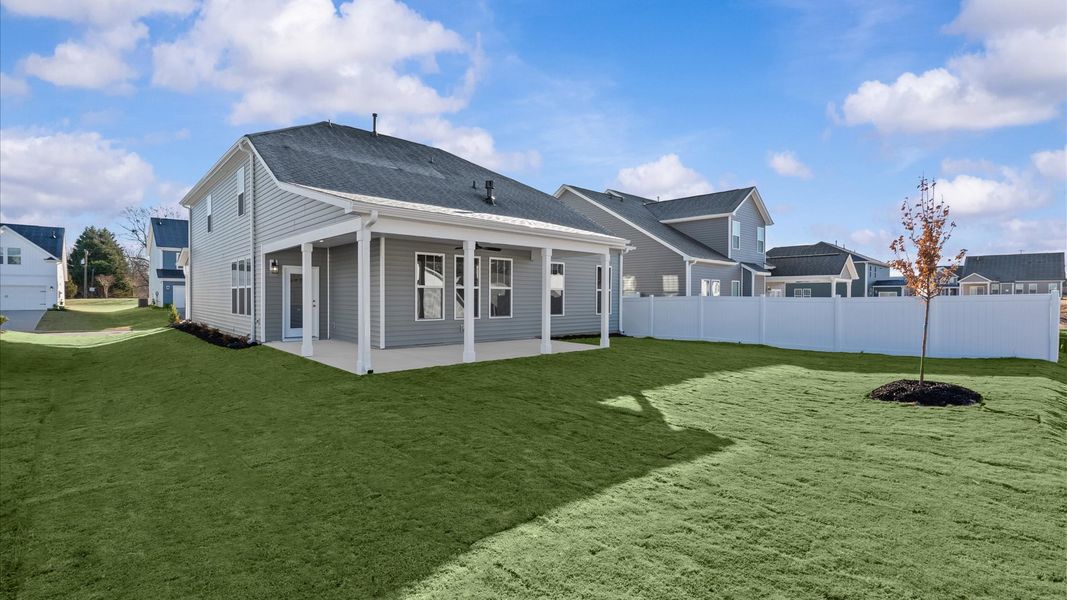 Superior curb appeal continues to the back with a refined, covered outdoor living space