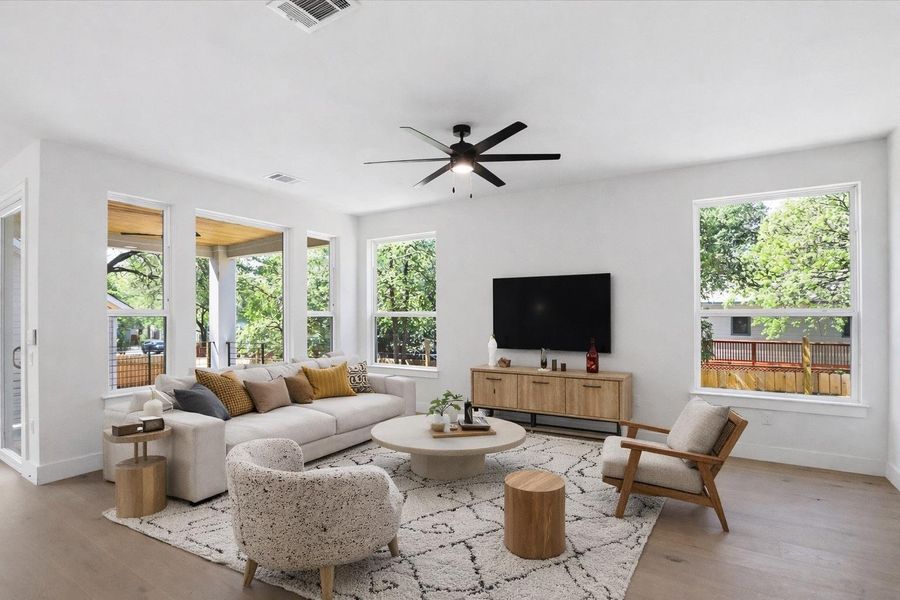 Living room featuring light wood-type flooring and ceiling fan