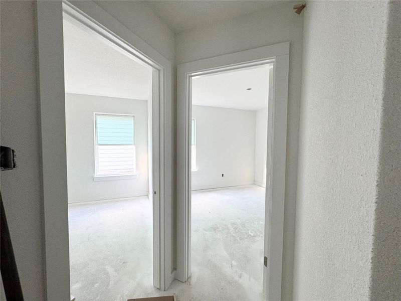 Hall with unfinished concrete flooring