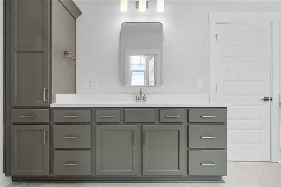 A well-appointed primary bathroom vanity featuring A well-appointed primary bathroom vanity featuring