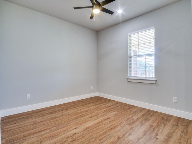 Unfurnished room with ceiling fan and light hardwood / wood-style flooring