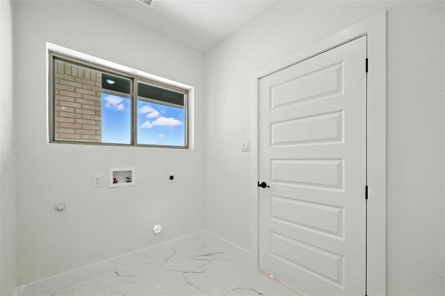 Laundry room with gas dryer hookup, light marble finish flooring, hookup for an electric dryer, and hookup for a washing machine