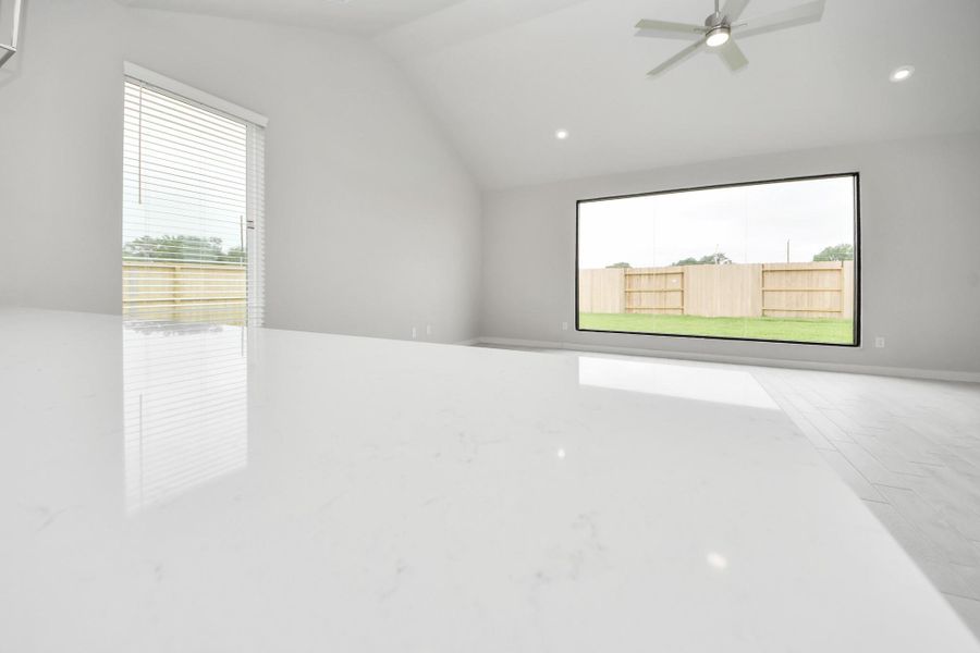 Bring your loved ones and guests together in the inviting living room! Boasting lofty high ceilings, recessed lighting, a stylish ceiling fan, custom paint, stunning flooring, and expansive windows that flood the space with ample natural light all day long. Sample photo of completed home with similar floor plan. Actual colors and selections may vary. Bring your loved ones and guests together in the inviting living room! Boasting lofty high ceilings, recessed lighting, a stylish ceiling fan, custom paint, stunning flooring, and expansive windows that flood the space with ample natural light all day long. Sample photo of completed home with similar floor plan. Actual colors and selections may vary.