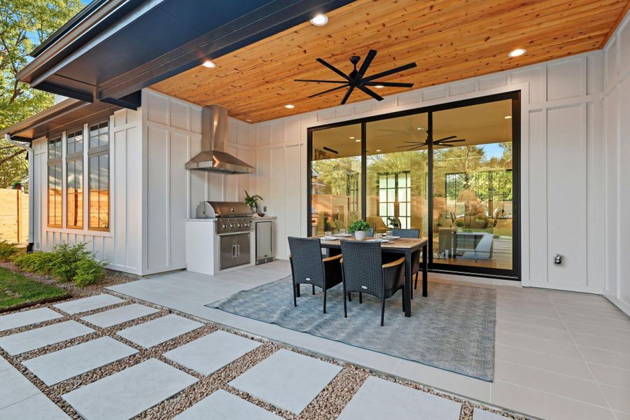 View of patio featuring outdoor dining area, exterior kitchen, and ceiling fan