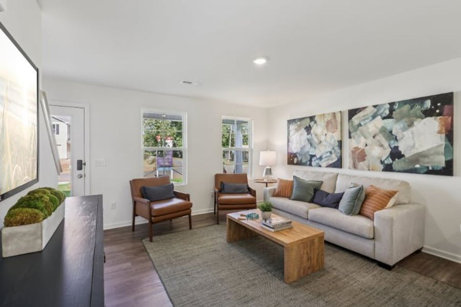 A living room with a couch and a coffee table. A living room with a couch and a coffee table.