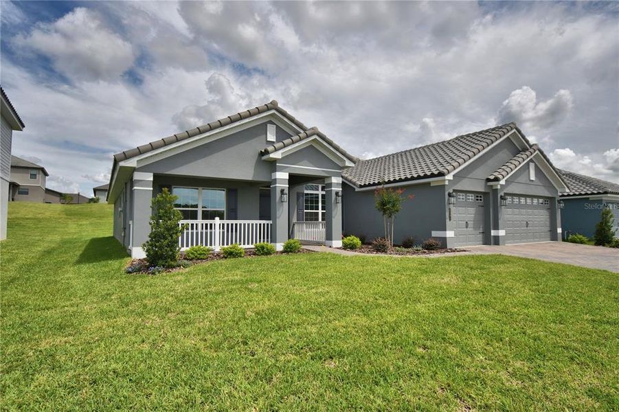 Front exterior of a new home in , Auburndale, FL, highlighting curb appeal (Image 26). Front exterior of a new home in , Auburndale, FL, highlighting curb appeal (Image 26).