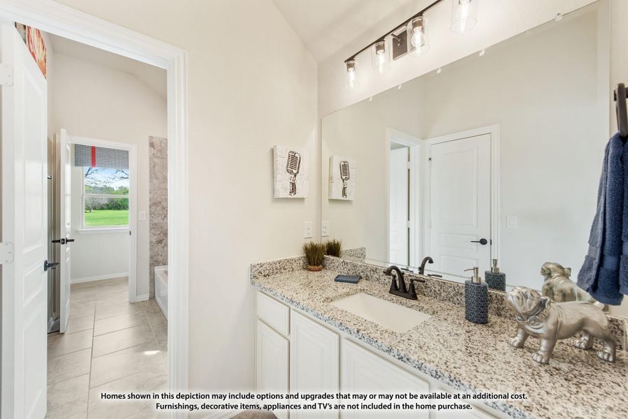 Bathroom with white vanity, granite countertop, large mirror, and tile floors with soaking tub visible in background