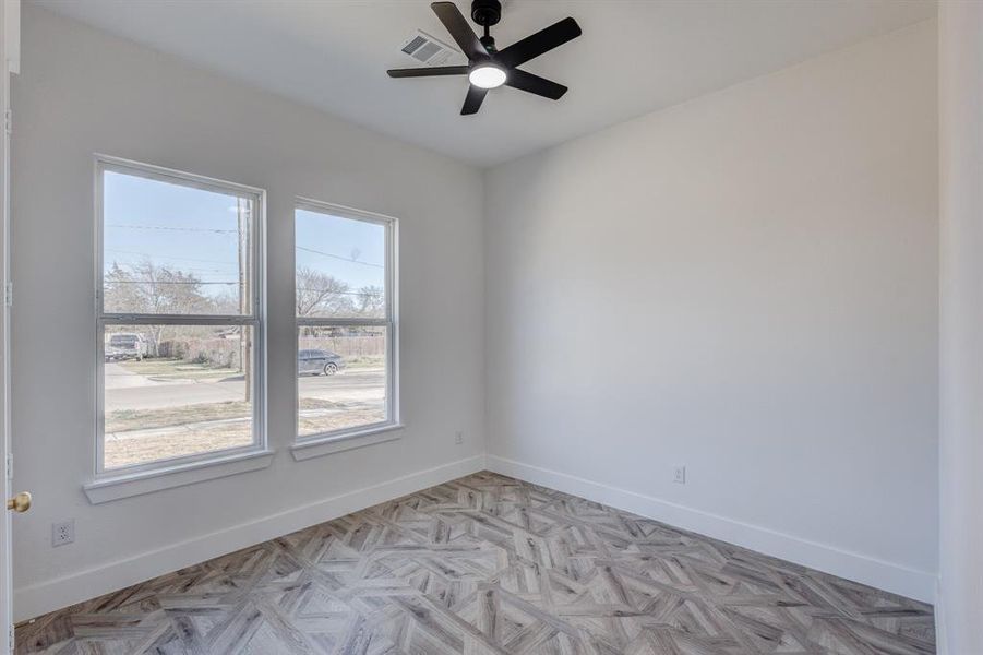 Spare room featuring light parquet floors and ceiling fan