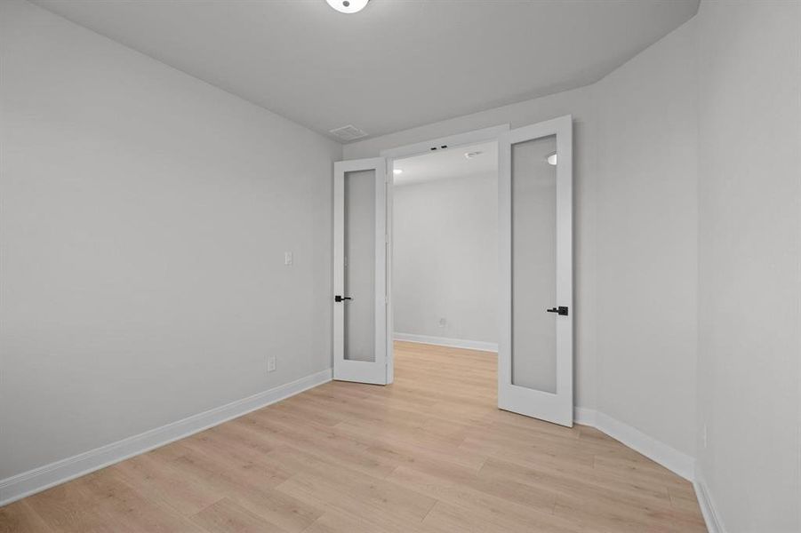 Light wood-finish flooring throughout, complemented by white baseboards and neutral wall tones Light wood-finish flooring throughout, complemented by white baseboards and neutral wall tones