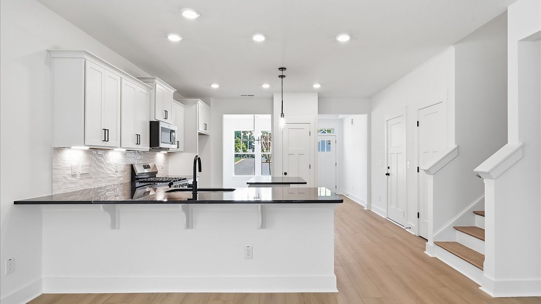 Elegant and compact island anchors this tasteful kitchen with high standards and timeless appeal Elegant and compact island anchors this tasteful kitchen with high standards and timeless appeal