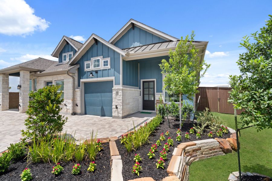 Front exterior of a new home in Meridiana, Manvel, TX, highlighting curb appeal (Image 21).