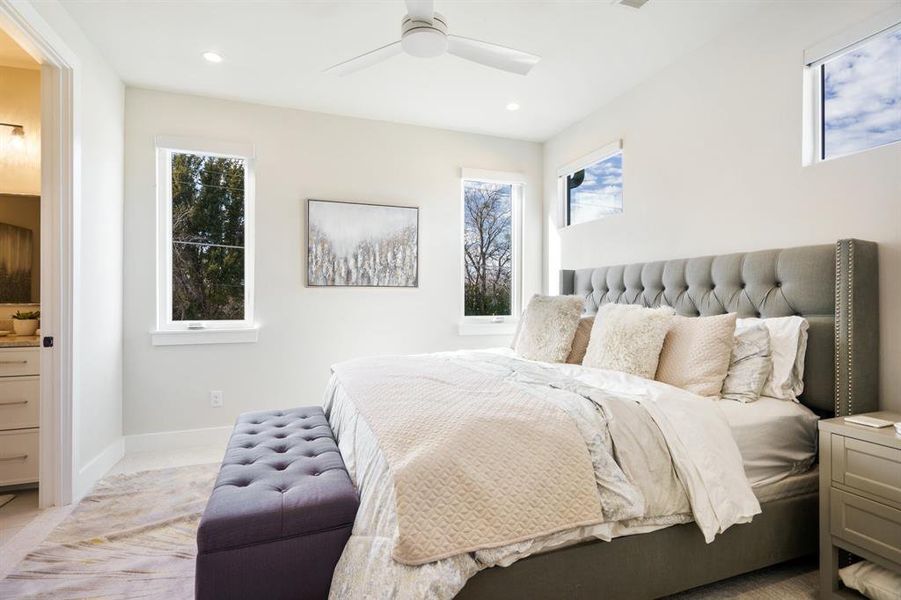 Bedroom featuring multiple windows and ceiling fan