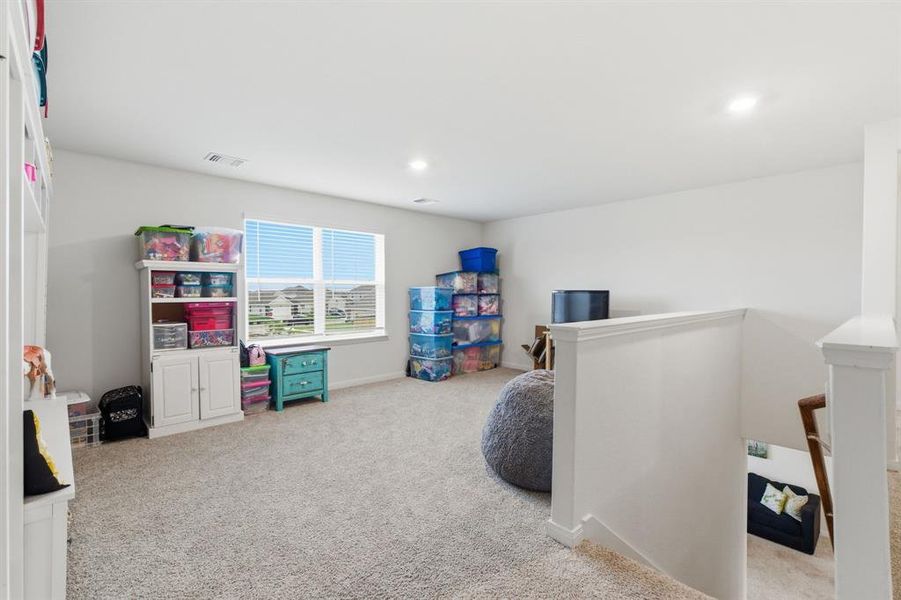 Carpeted room with white walls, a window with blinds, and white trim