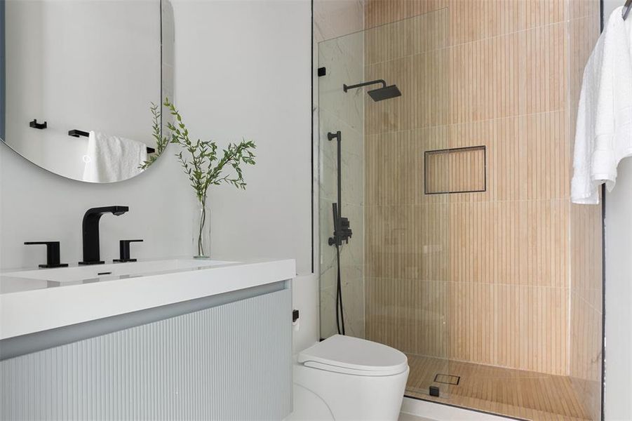 Bathroom featuring vanity, an enclosed shower, and toilet