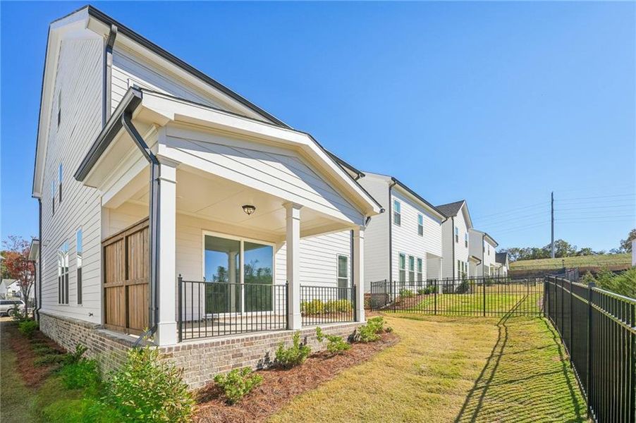 Exterior details and patio area of a home in Palisades Single Family, Cumming (Image 32).