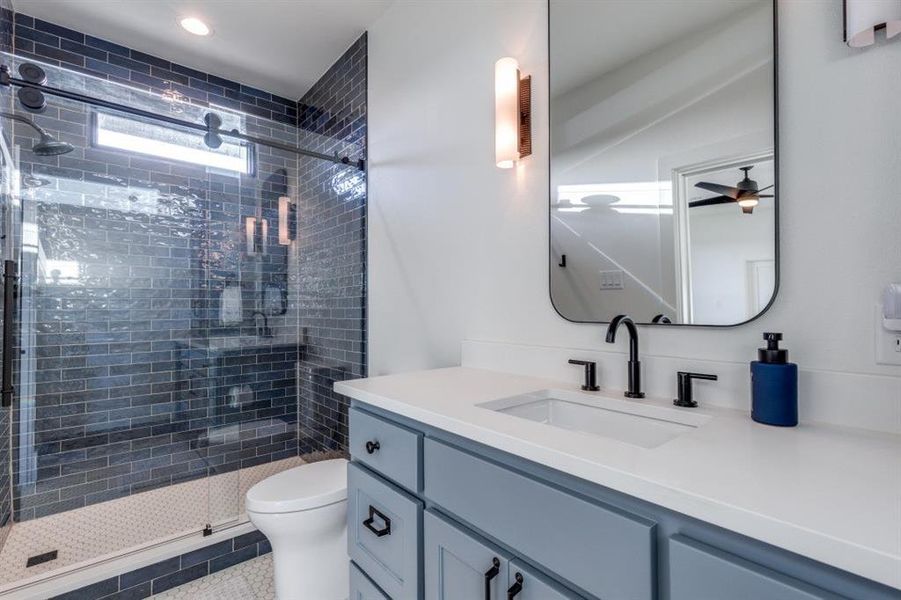 Bathroom featuring vanity and a stall shower Bathroom featuring vanity and a stall shower